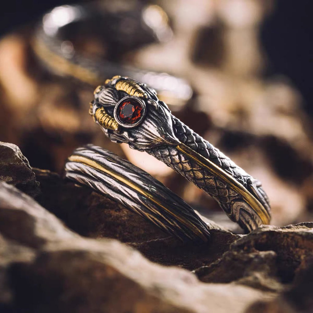 Close-up detail of gold overlay craftsmanship and natural garnet setting on silver ring