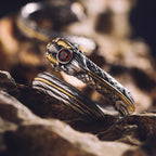 Close-up detail of gold overlay craftsmanship and natural garnet setting on silver ring